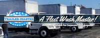 a fleet wash master logo with trucks parked in a parking lot